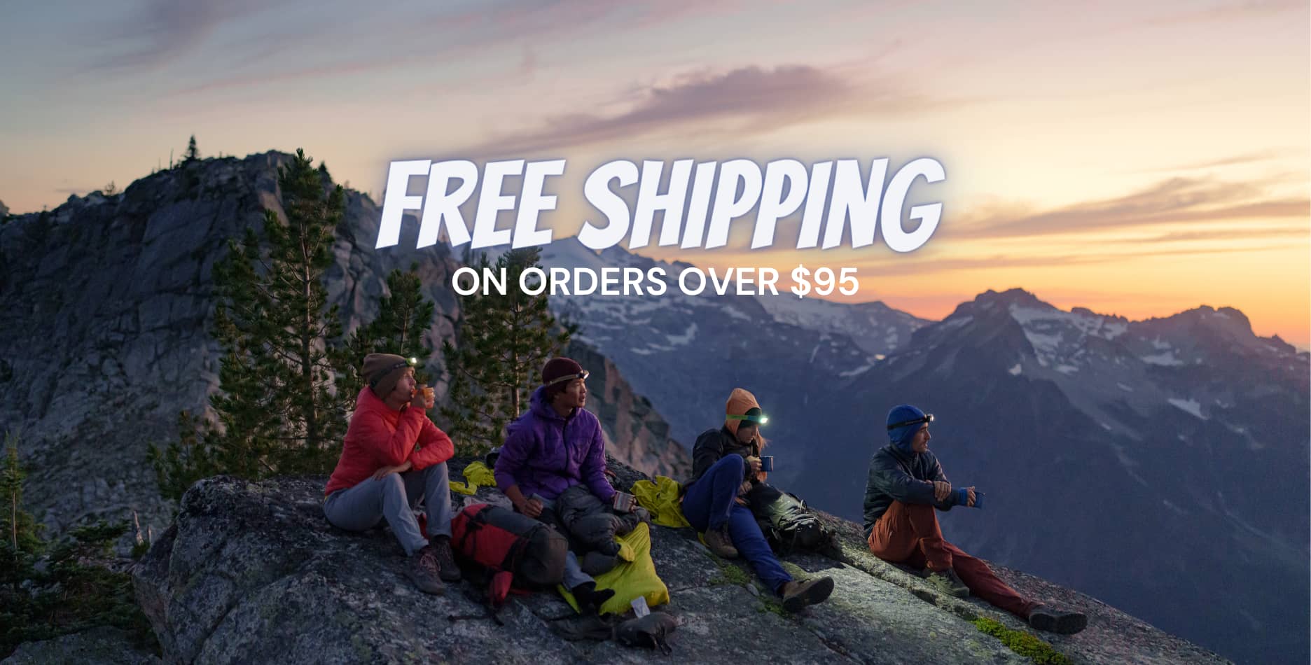 Four people on a mountain under the text "free shipping on orders over $95"